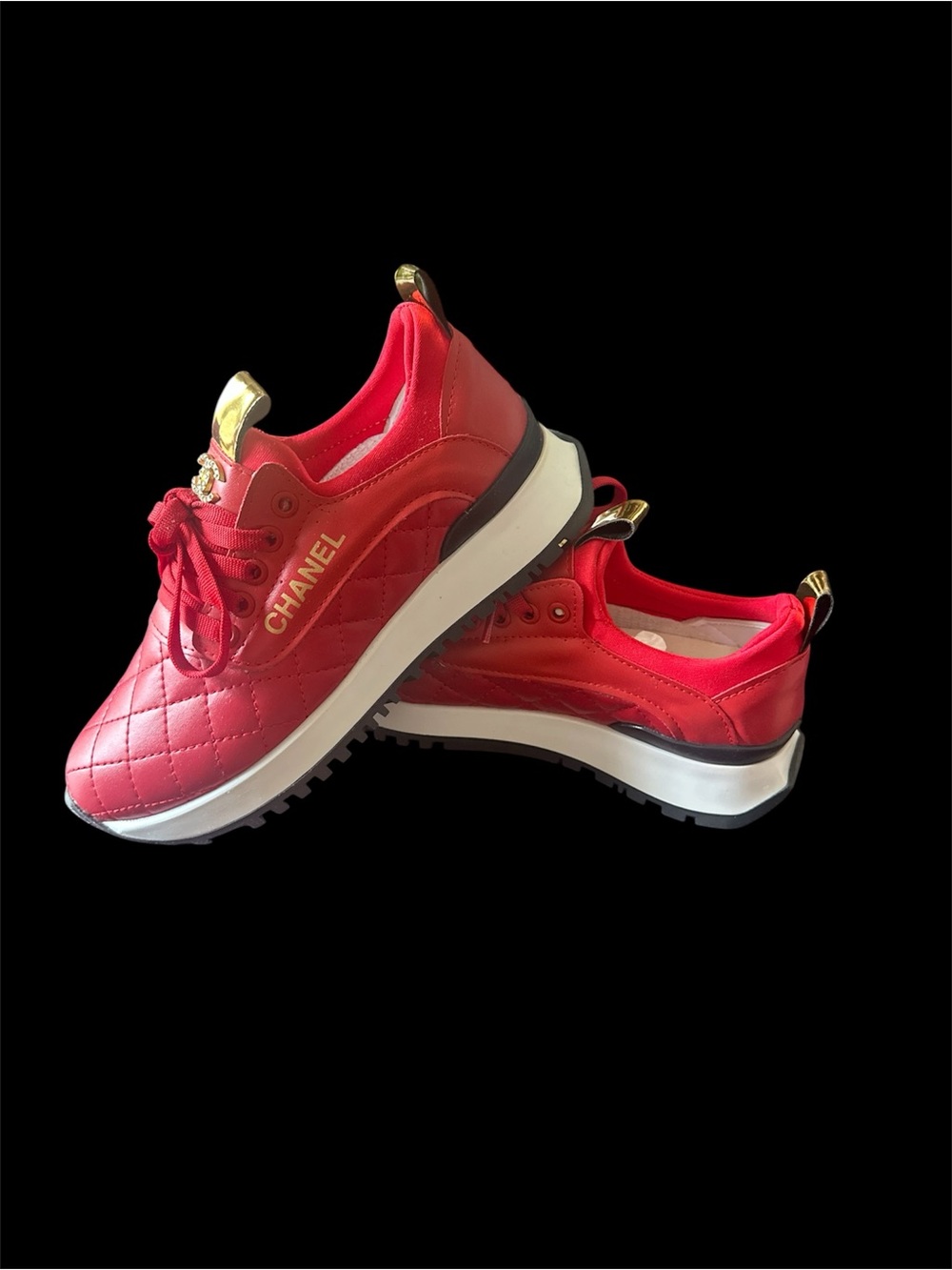 CHANEL Red Quilted Sneakers with Gold Accents